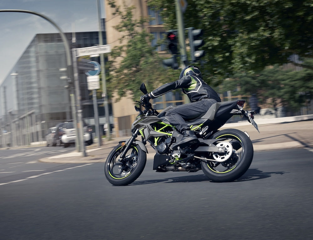 man riding kawasaki motorcycle