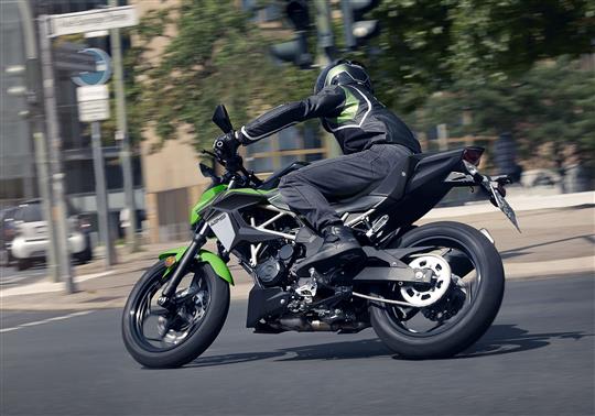 Person on a green kawasaki motorbike